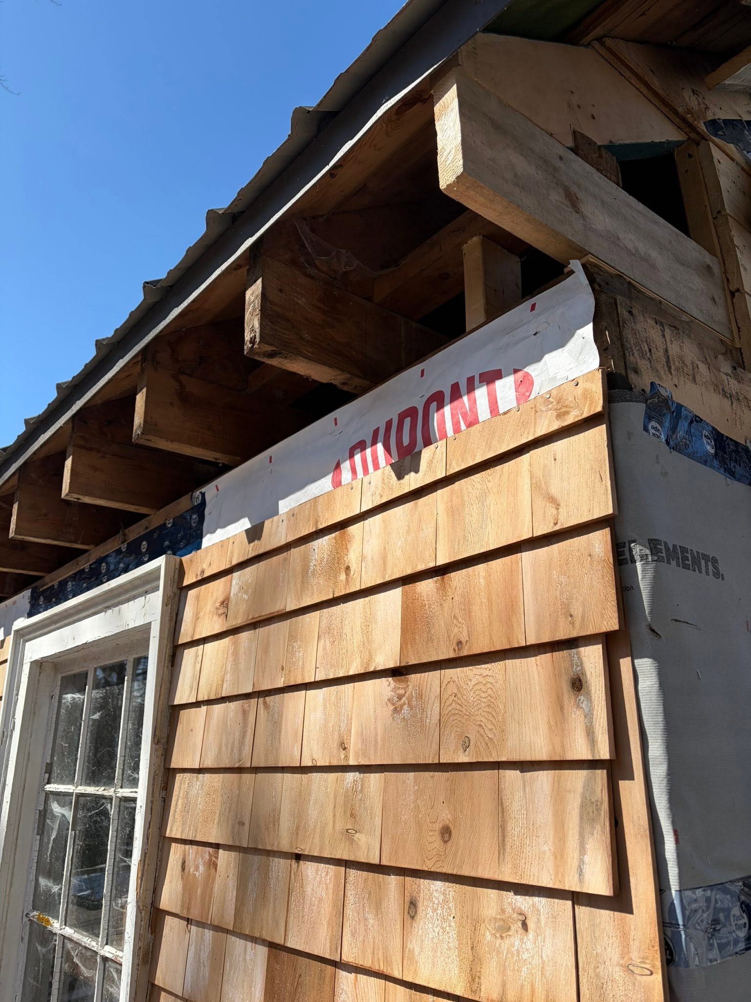 Cedar siding installation in progress