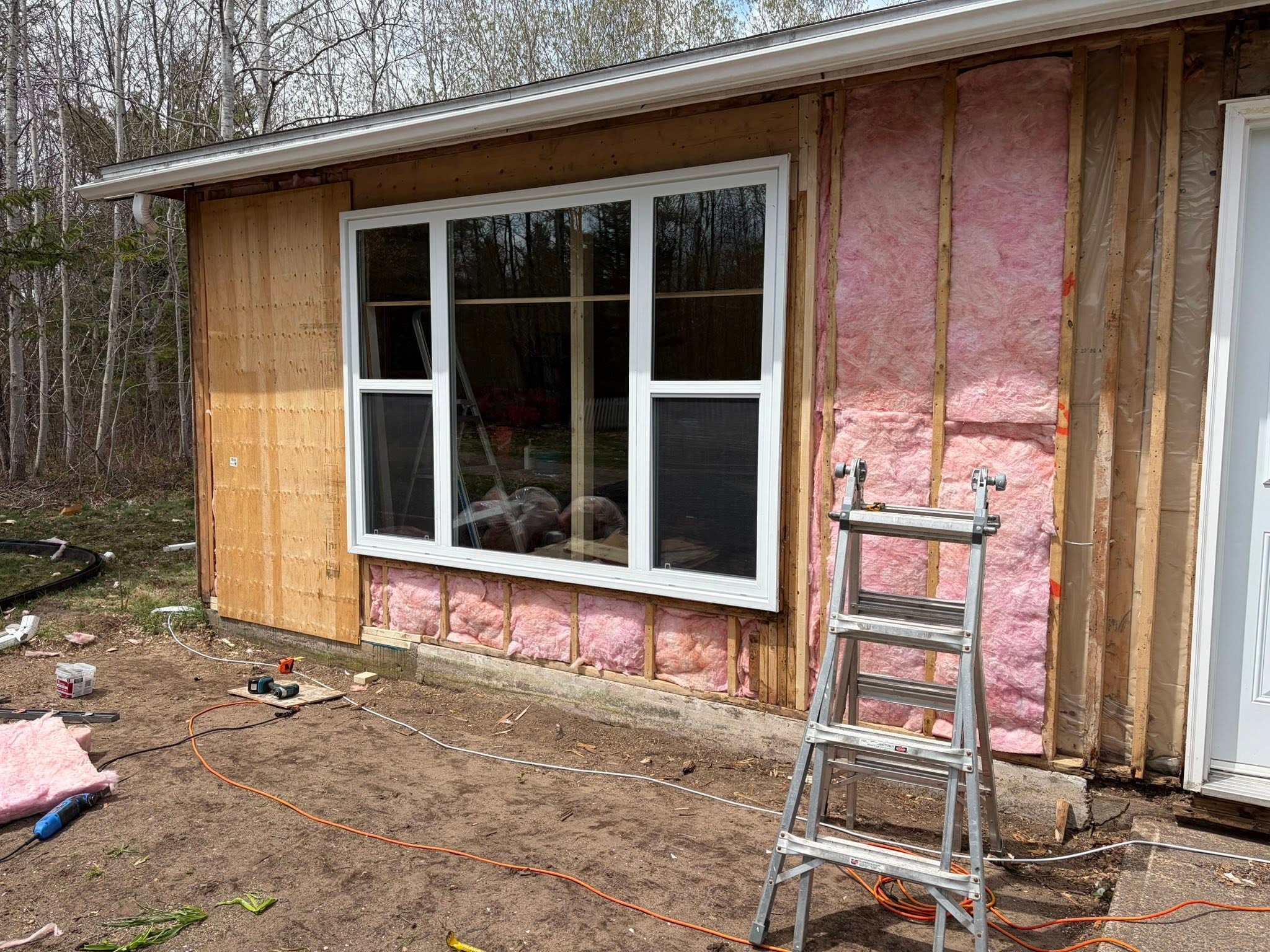 Wall framing and insulation exposed during structural renovation work